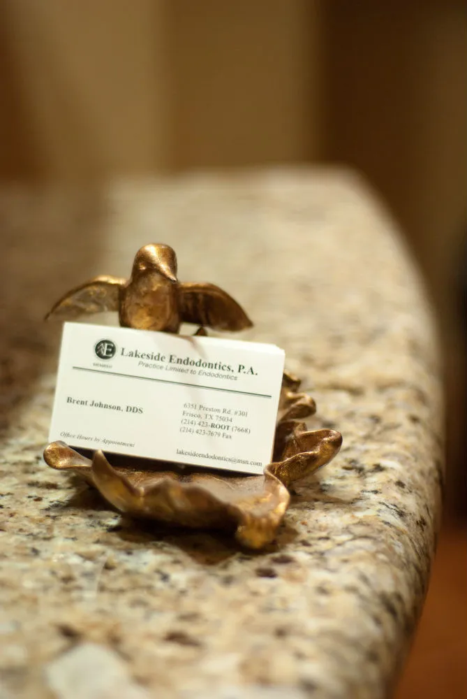 Interior photo: Frisco TX Endodontics business card in brass holder: Lakeside Endodontics